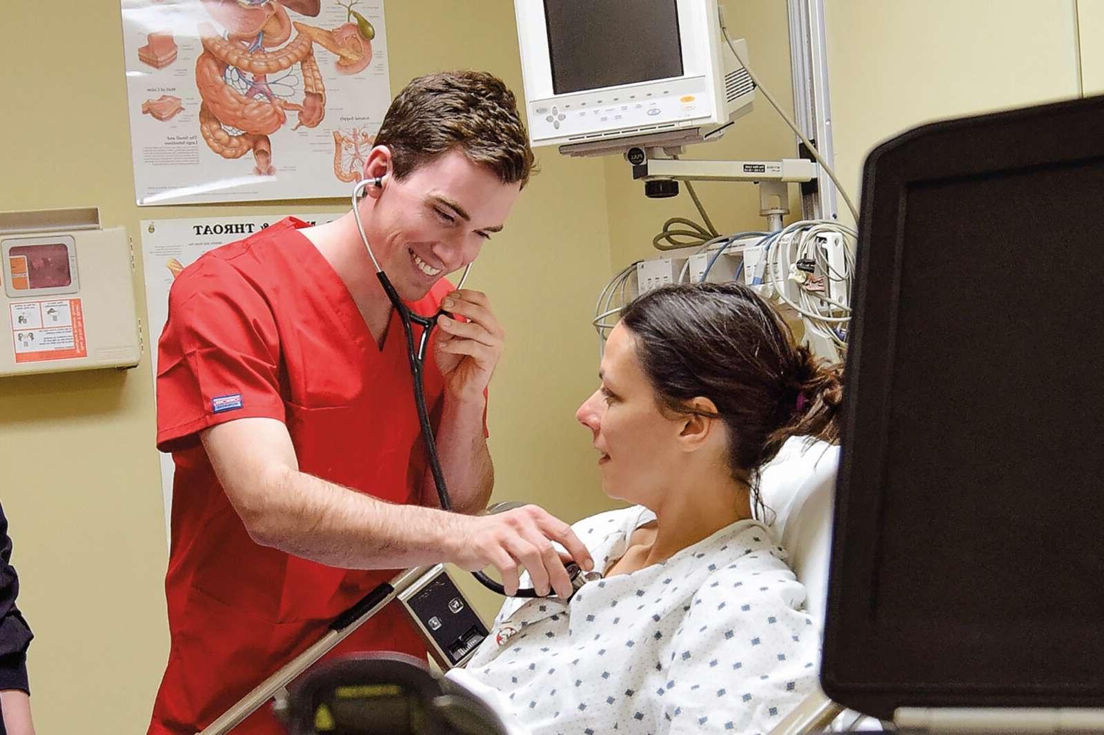 nursing students listening through a stethescope